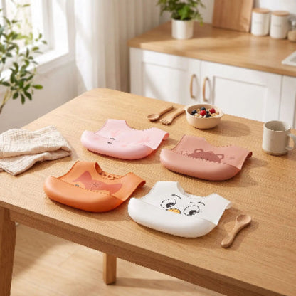 Bavoirs imperméable bébé silicone poche avec quatre bavoirs différentes sur la table de cuisine